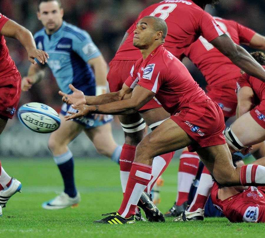 Reds scrum-half Will Genia feeds his back division
