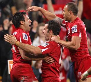 The Reds' Rod Davies is engulfed after scoring a try, Reds v Blues, Super Rugby semi-final, Suncorp Stadium, Brisbane, Australia, July 2, 2011