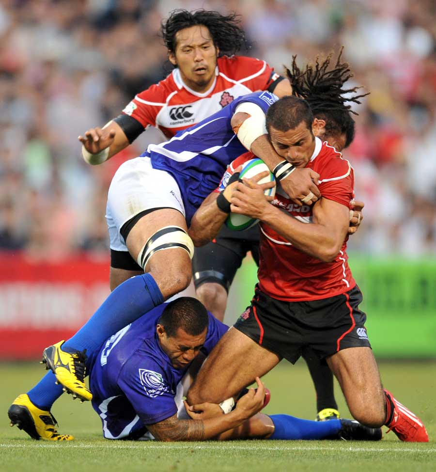 Japan's Ryan Nicholas is shackled by the Samoa defence