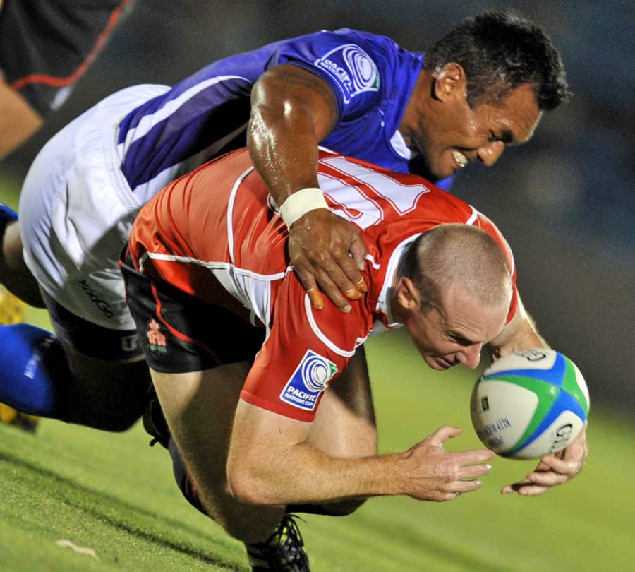 Samoa's Uale Mai tackles Japan's Shaun Webb