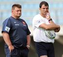France coach Marc Lievremont (right) and forwards coach Didier Retiere cast an eye over training