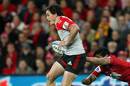 Zac Guildford of the Crusaders tries to break through the Reds defence