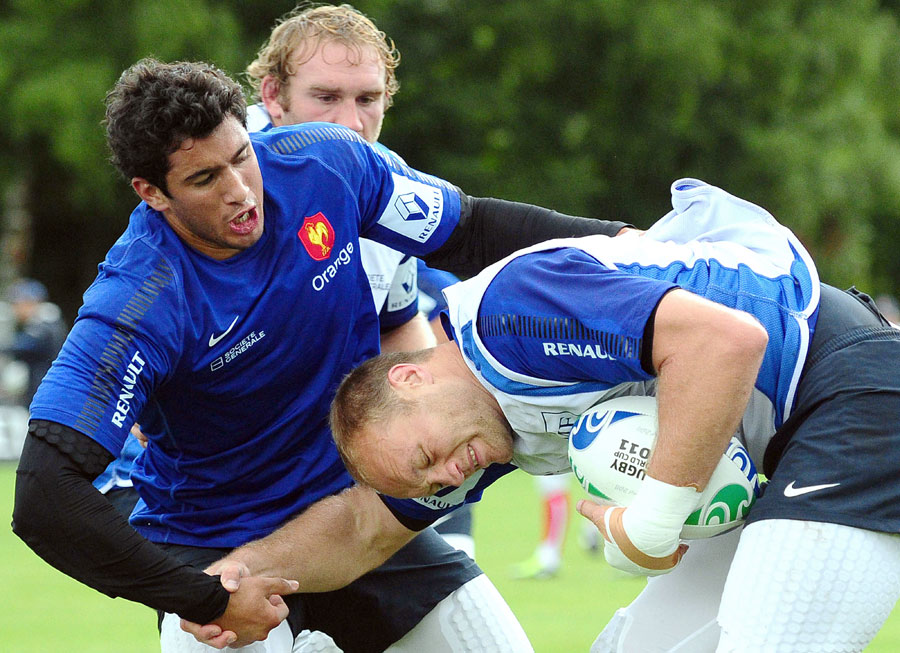 France flanker Julien Bonnaire is tackled by Maxime Mermoz