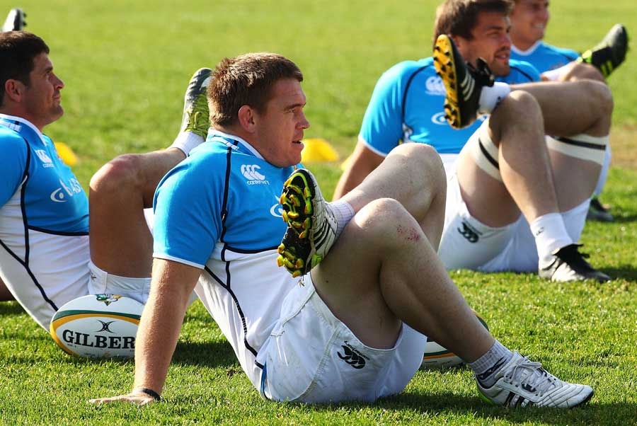 John Smit listens intently while stretching