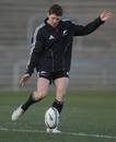 All Blacks fly-half Colin Slade kicks during training
