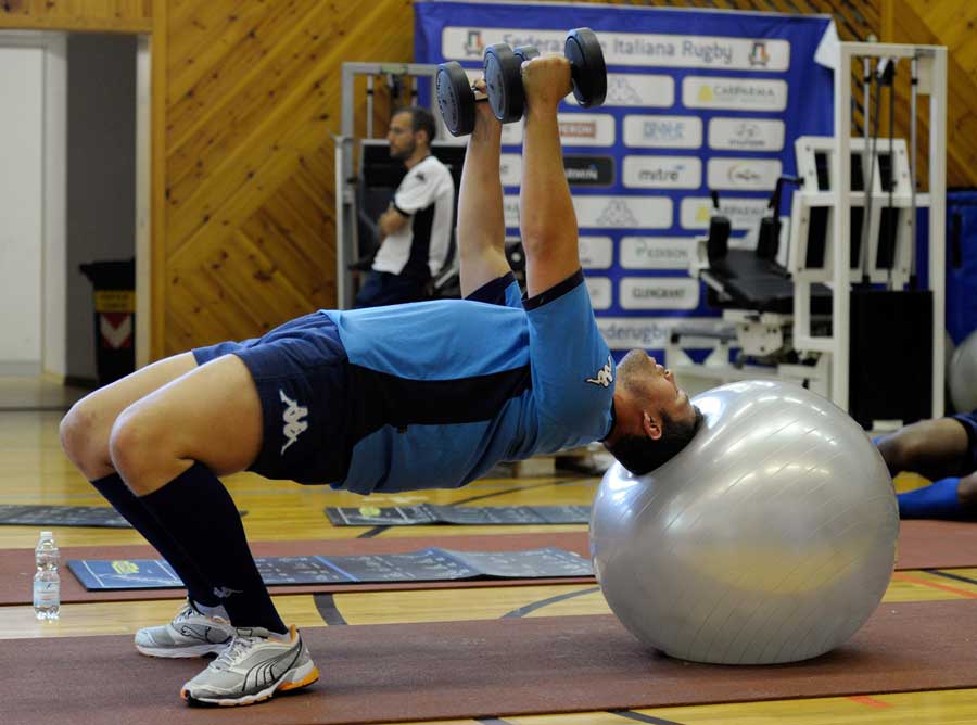 Italy lock Carlo del Fava lifts weights on an exercise ball