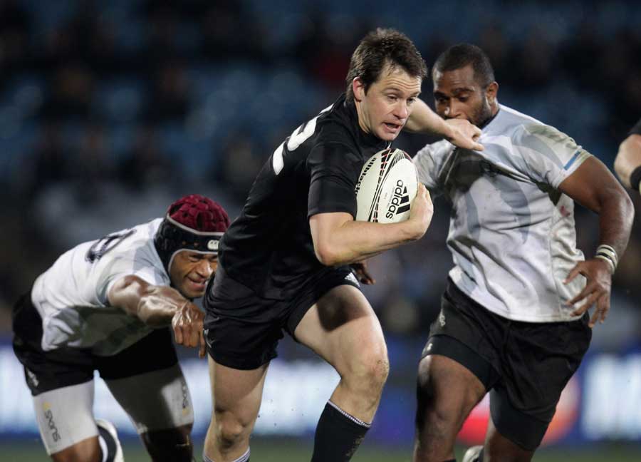 All Blacks wing Ben Smith breaks a tackle