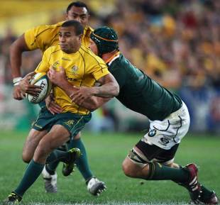 Australia's Will Genia tries to get away from his South African opponent, Australia v South Africa, Tri-Nations, ANZ Stadium, Sydney, Australia, July 23, 2011