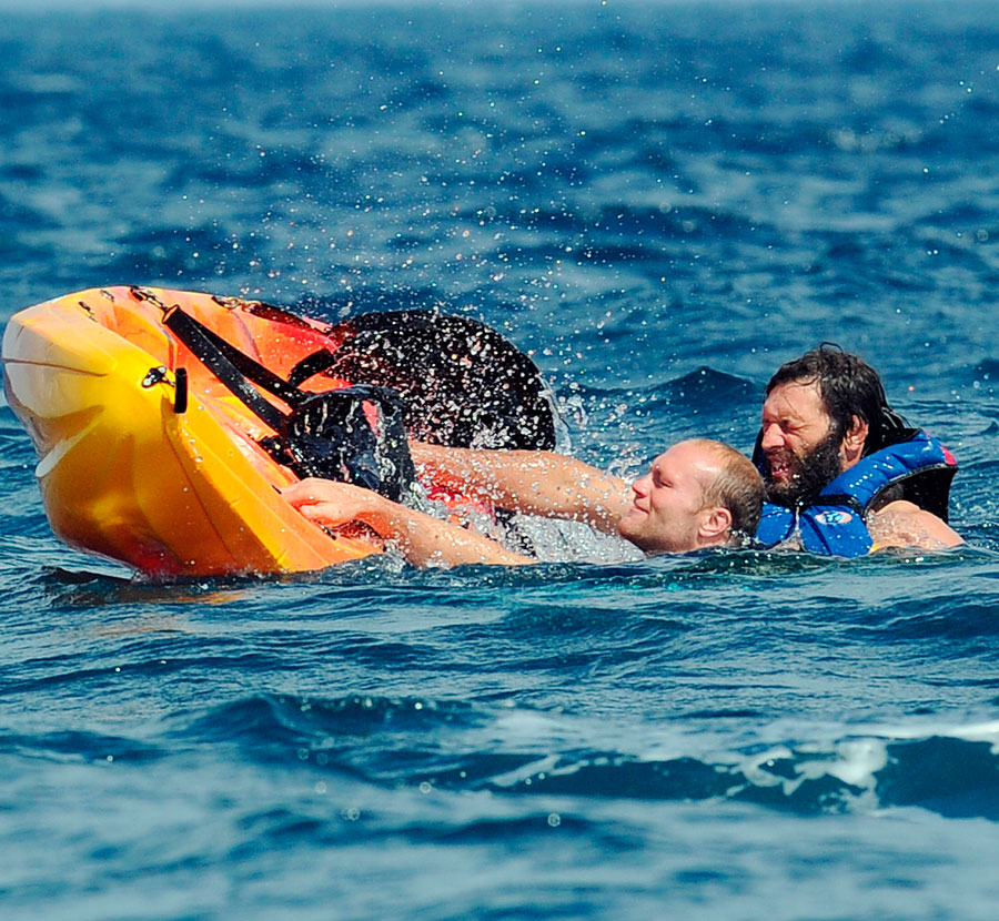 France's Julien Bonnaire (L) and Lionel Nallet (R) struggle to get back into their kayak
