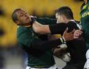 South Africa's Juan de Jongh gets to grips with All Blacks winger Cory Jane