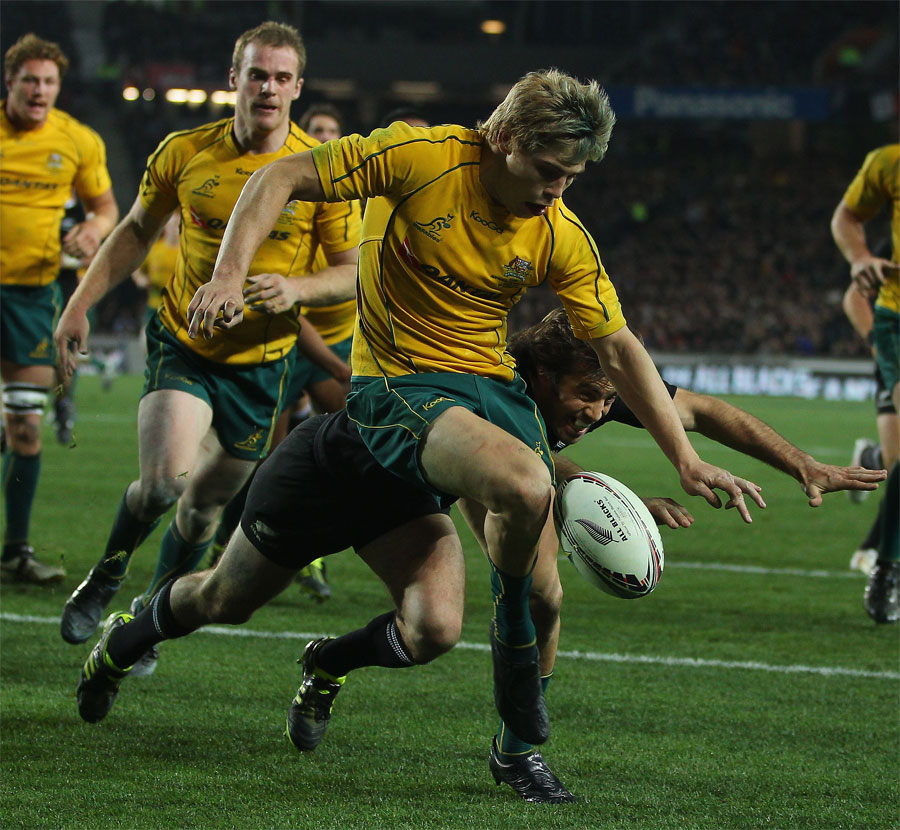Australia wing James O'Connor hacks the ball away