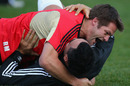 The All Blacks captain Richie McCaw wrestles with Victor Vito