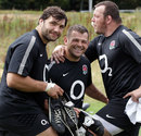 England's Alex Corbisiero, Lee Mears and Steve Thompson prop each other up during training