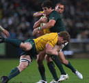 Australia's David Pocock launches into a tackle on South Africa's Jaque Fourie