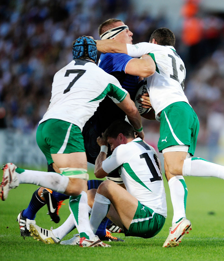 France's Imanol Harinordoquy is wrapped up by the Ireland defence