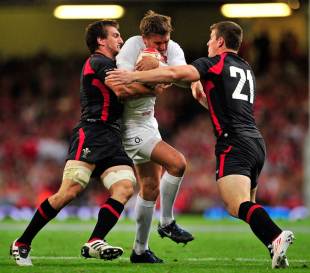 England fly-half Toby Flood is hauled in by Sam Warburton, Wales v England, World Cup warm-up Test, Millennium Stadium, Cardiff, Wales, August 13, 2011