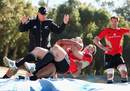 All Blacks fly-half Colin Slade is tackled onto a high jump mat during training