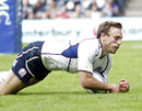 Scotland scrum-half Mike Blair dives on the ball to score following a charge down