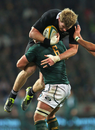 South Africa' Heinrich Brussow tackles New Zealand's Adam Thomson