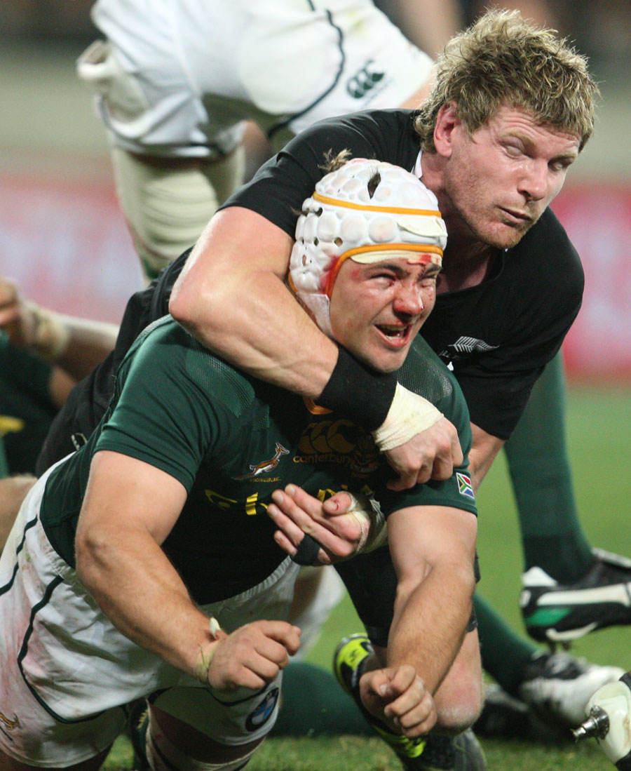New Zealand's Adam Thomson gets to grips with South Africa's Heinrich Brussow