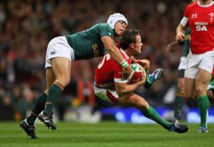 Lee Byrne of Wales is tackled by Adi Jacobs of South Africa during the Invesco Perpetual Series match between Wales and South Africa at the Millennium Stadium in Cardiff, Wales on November 8, 2008.