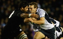 Liam Messam of New Zealand tackles Mike Blair of Scotland 