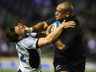 Neemia Tialata of the All Blacks fends off Nick de Luca (L) during the Scotland and New Zealand All Blacks rugby match at Murrayfield in Edinburgh, Scotland on November 8, 2008.