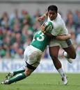 England's Manu Tuilagi gets hauled down by Ireland's Keith Earls