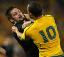 Australia's Quade Cooper gets to grips with New Zealand's Richie McCaw