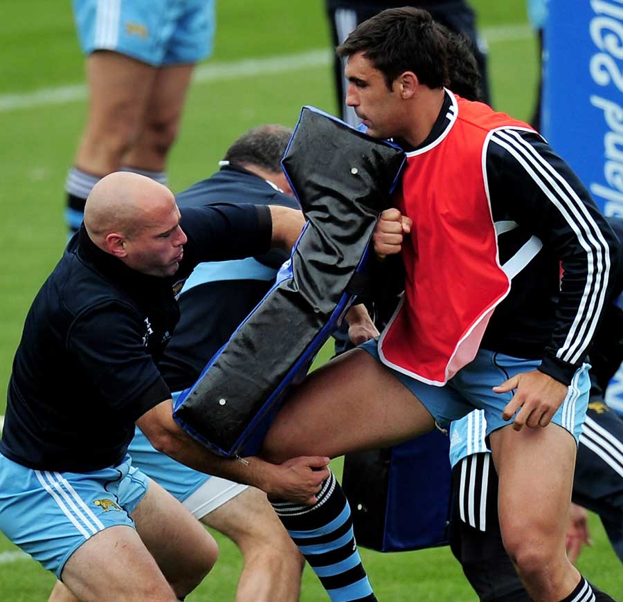 Argentina's Felipe Contepomi feels the force of the tackle bag during training
