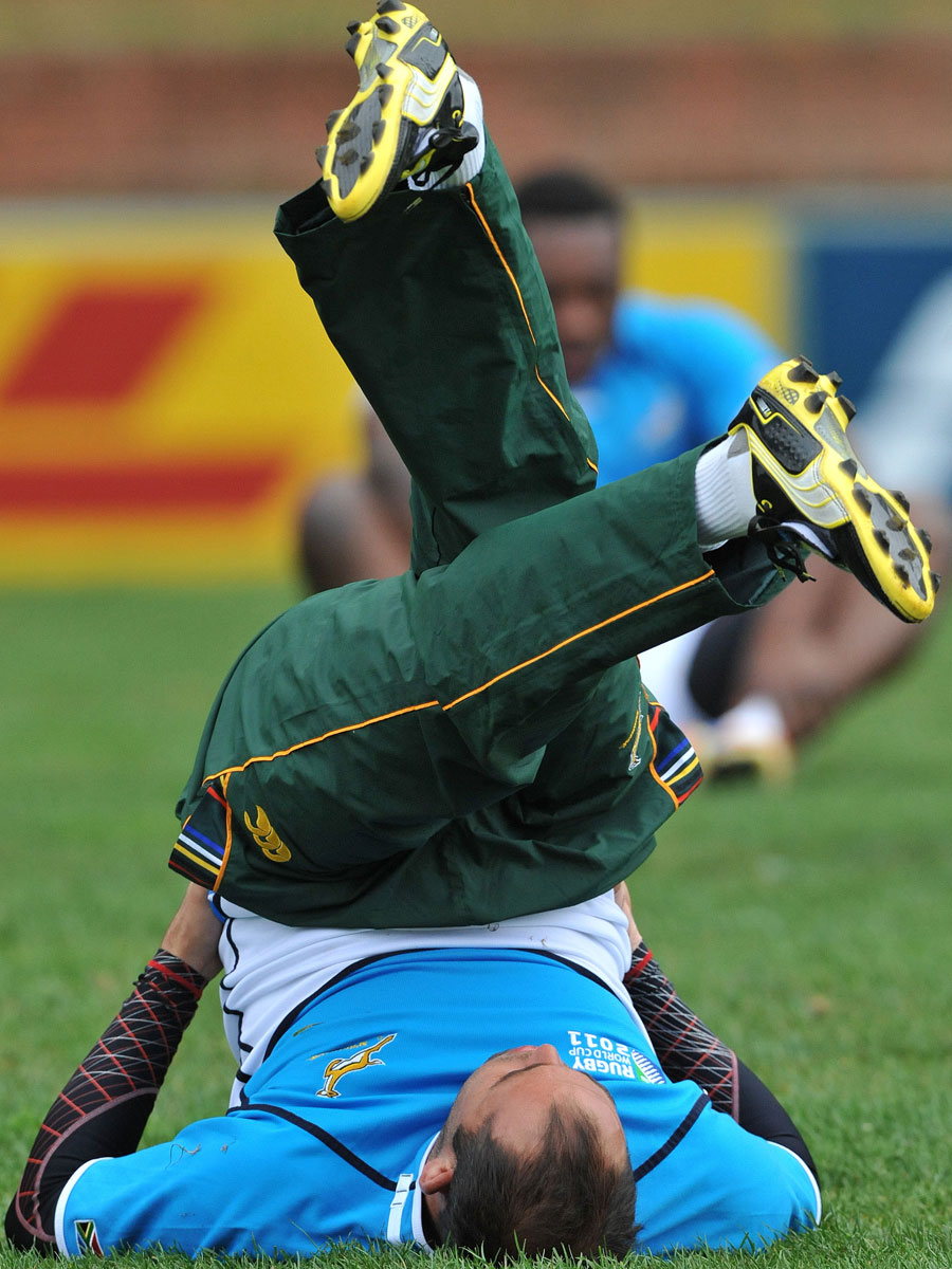 South Africa's Fourie Du Preez stretches during training 