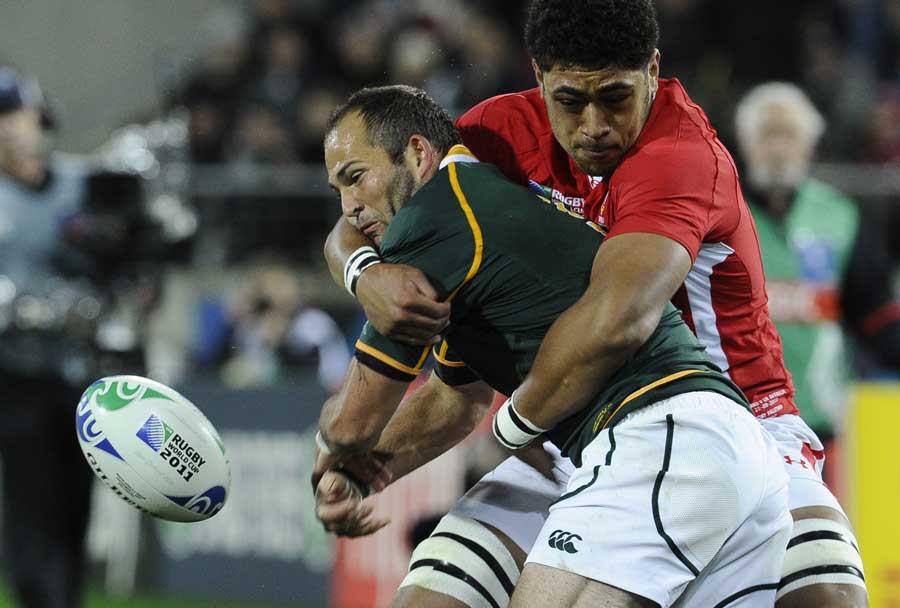 South Africa's Fourie du Preez is wrapped up by Toby Faletau