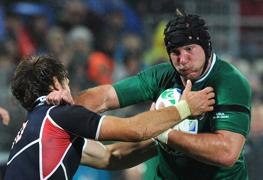 Ireland flanker Stephen Ferris hands off Blaine Scully