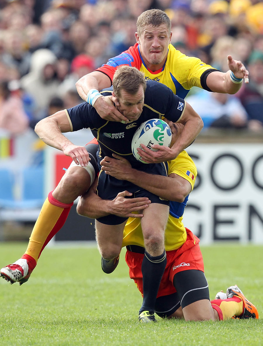 Scotland's Chris Paterson is held by the Romania defence