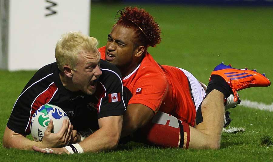 Canada's Phil Mackenzie of Canada goes over to score a try 