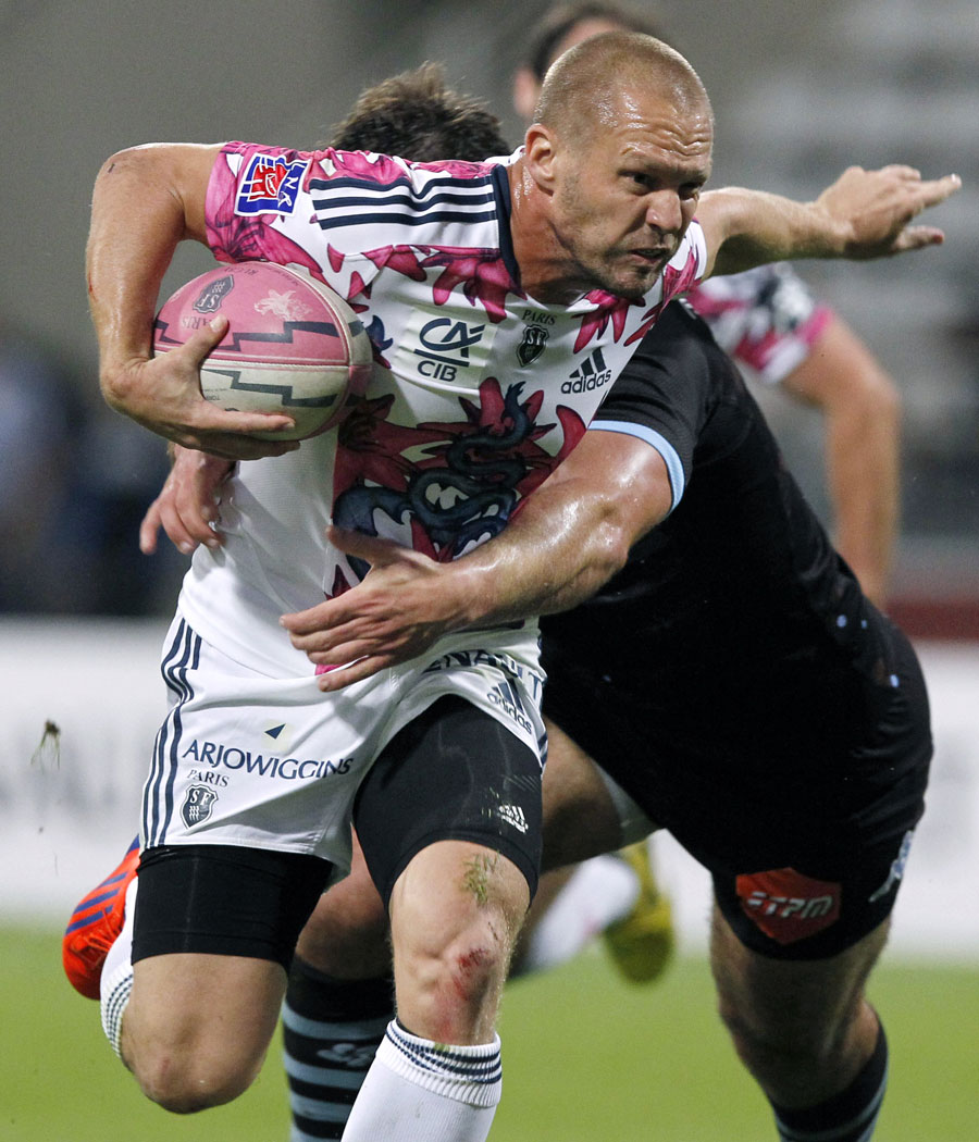 Stade Francais' Paul Warwick holds off the defender