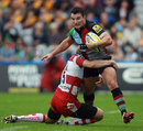 Harlequins' George Lowe is tackled by Gloucetser's Olly Morgan