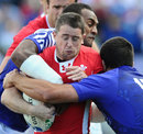 Wales winger Shane Williams is wrapped up by the Samoa defence