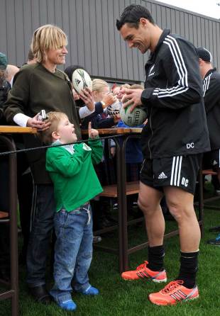 All Blacks fly-half Dan Carter signs autographs for a fan, Christchurch, New Zealand, September 19, 2011