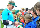 South Africa's Jean de Villiers smiles as he signs autographs during training