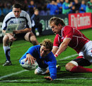 Italy' Giulio Toniolatti  dives in at the corner for his first international try