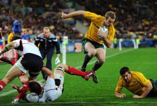 Australia's Pat McCabe hurdles the challenge to dive over the line, Australia v USA, Rugby World Cup, Wellington, New Zealand, September 23, 2011