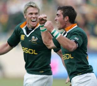 Jean De Villiers and Ruan Pienaar celebrate following South Africa's Tri Nations victory over New Zealand at Royal Bafokeng Stadium, September 2 2006