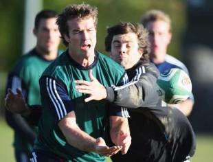 Jason Eaton passes the ball under pressure from Conrad Smith (R) of the All Blacks in action during a New Zealand All Black training session at Westmanstown sports complex in Dublin Ireland on November 11, 2008
