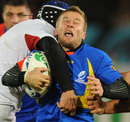 Romania's Florin Surugiu is halted in the tackle