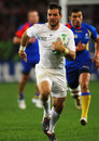 England's Ben Foden shows a clean pair of heels to the Romanian defence 