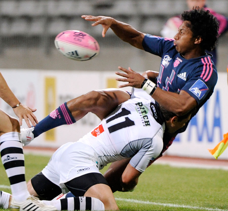 Stade Francais wing Francis Fainifo manages to offload in the tackle
