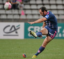 Stade Francais scrum-half Julien Dupuy kicks a penalty