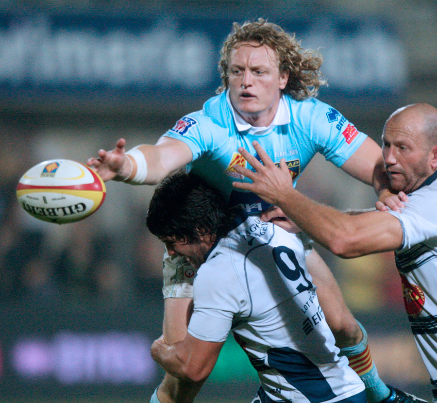 Perpignan centre Ryan Cross offloads in the tackle
