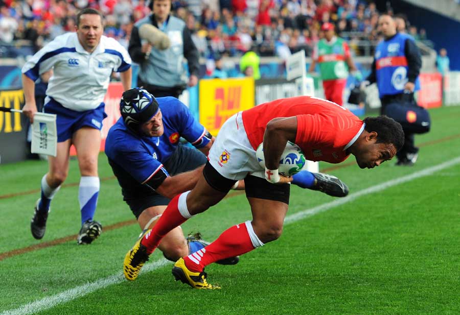 Tonga's Suka Hufanga crosses the line for their first try of the match